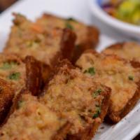 Thai Toast · Deep fried ground pork and shrimp with chef's spices on bread. Served with fresh cucumbers.