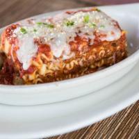 Lasagna · Layered pasta with beef, tomato sauce, mozzarella, parmesan and ricotta cheese.