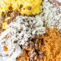 Chilaquiles · Tortillas chips and two eggs. Choice of red or green sauce, queso fresco, sour cream. Served...