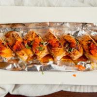 Spicy Baked Salmon Roll · Spicy. Baked spicy crab, avocado inside with salmon topped with masago and green onion.