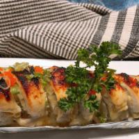 Snow Roll · Spicy. Baked crab, avocado, cream cheese inside with escolar on topping with masago, green o...