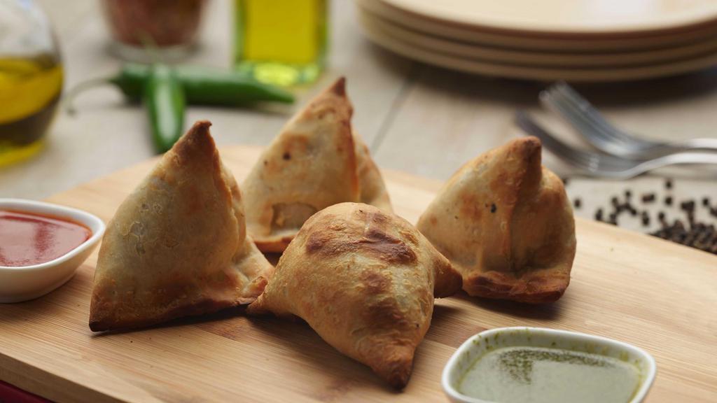 Samosa (2) · Our samosas are stuffed with potatoes, peas, and spices, and served with a side of our signature dipping sauce