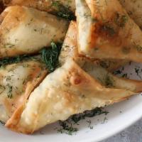 Spinach And Feta Samosas  · 4 pcs of Spinach and feta cheese warped in fresh made dough