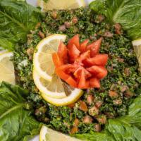 Tabbouleh Salad · Finely chopped parsley, mint, tomatoes, green onions, cracked wheat, olive oil and lemon.