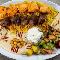 Mixed Grill Kabob Plate · one skewer chicken tawouk and one skewer beef kabob  sitting on rice with salad, humus, and ...