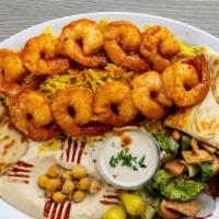 Shrimp Plate · 2 skewers shrimp sitting on rice with salad, hummus, and pita bread