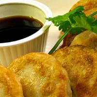 Potstickers · Steamed and then pan-fried: ground pork, . Chinese greens, ginger and scallions. . Served wi...