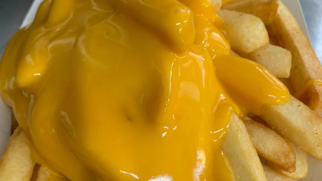 Cheese Fries  · Crispy fries topped with nacho cheese.