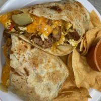 Breakfast Burrito · Two scrambled eggs, potatoes, and cheddar cheese wrapped in a flour tortilla. With a side of...