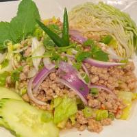 * Larb * · Spicy. Choice of ground chicken or pork in spicy lime dressing fish sauce, with red and gree...