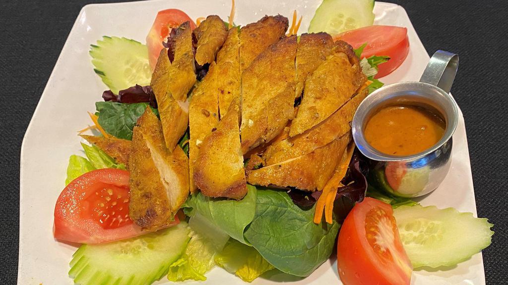 * Chicken Satay Salad * · Spicy. Marinated grilled chicken served with spring mix salad, red onions, cut  tomatoes, and sliced cucumbers on a bed of romaine and iceberg lettuce with our crafted peanut dressing and our sweet vinegar.