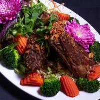 * Garlic & Pepper Pork Ribs * · Spicy. Lightly golden fried pork  spare ribs (12oz) served on a bed of sliced cabbage, steam...