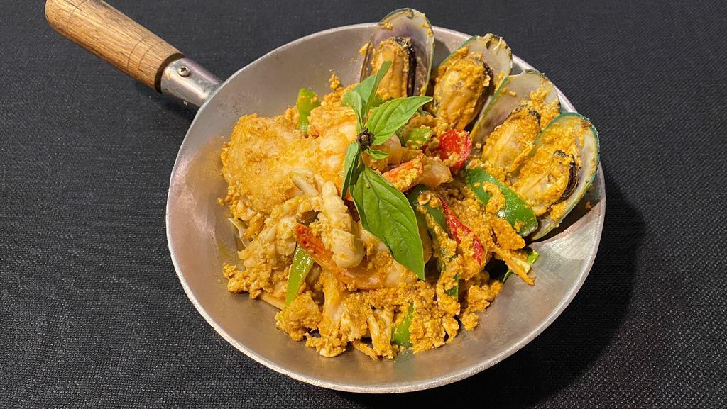 * Hor Mok Talay * · Spicy. Gluten free. Steamed seafood (calamari, fish, shrimp, green mussels) in red curry, egg, red & green bell peppers, pickled krachai, and Thai basil on a bed of cut cabbage.