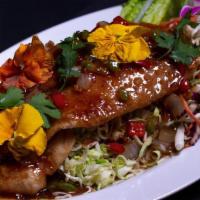 * Three Flavors Fish * · Spicy. Lightly crispy fish fillet (12 oz) on a bed of sliced cabbage garnished with tamarind...