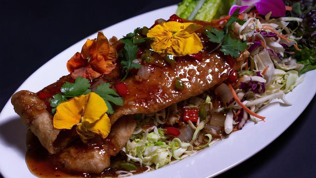* Three Flavors Fish * · Spicy. Lightly crispy fish fillet (12 oz) on a bed of sliced cabbage garnished with tamarind sauce, sautéed green and red bell peppers, and white onions.