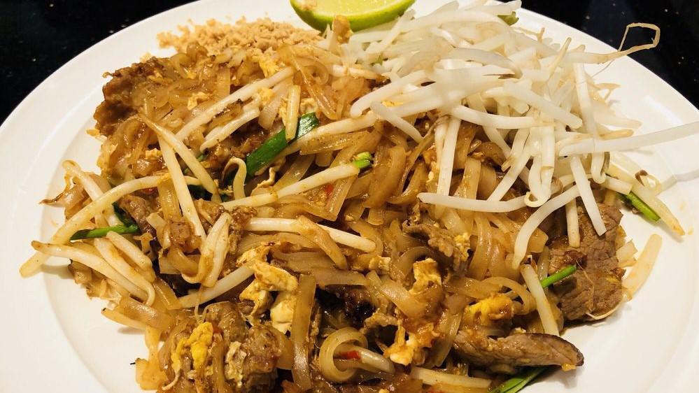 * L - Pad Thai * · Mild Spicy. Gluten free. Vegan. Thin rice noodles soft-fried in tamarind sauce with egg and bean sprouts. Garnished with crushed peanut. Served with House Salad & Egg Roll.
