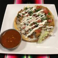 Tostada · Deep fried corn tortilla topped with beans, lettuce, pico de gallo,cotija cheese, sour cream...