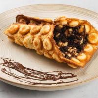 Nutella · Bubble waffle spread with Nutella™ Hazelnut throughout, drizzled with chocolate sauce.