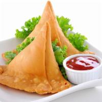 Vegetable Samosas (2 Pcs) · Masala seasoned potatoes, carrots and peas wrapped in a delicate pastry dough and fried unti...