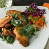 Herbal Wings · Marinated chicken wings, crispy basil, spicy sweet and sour sauce.