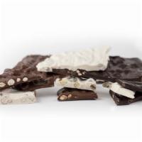 Nut Barks · Sheets of milk or dark chocolate with nuts broken into irregular shaped pieces.