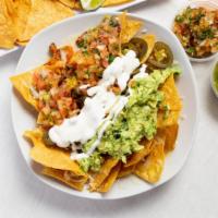 Super Nachos · With meat, melted cheese, beans, sour cream, guacamole, salsa and jalapeños.
