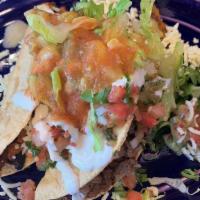 Crispy Tacos (2) · With two meat served with cheese, sour cream, guacamole, salsa, lettuce and tomatoes.