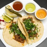 Street Tacos With Homemade Corn Tortilla · Street Tacos with Homemade corn tortilla
With your choice of Meat garnished with onion and c...