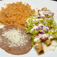 Flautas · Three flautas rolled in a crispy corn tortilla, choice of beef or chicken, topped with fresh...