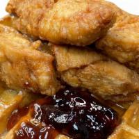 Chicken And Waffles · Three slightly seasoned Chicken Tenders on top of a waffle bed. Served with fruit jelly and ...
