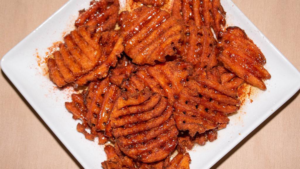 Sweet & Spicy Sweet Potato Waffle Fries · Spicy honey drizzle.