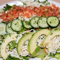 House Salad · Chopped romaine, power blend slaw, shredded mozzarella cheese, cucumber, tomato, avocado.