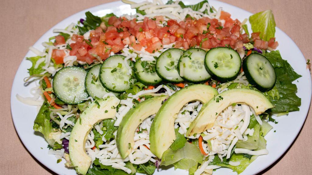 House Salad · Chopped romaine, power blend slaw, shredded mozzarella cheese, cucumber, tomato, avocado.