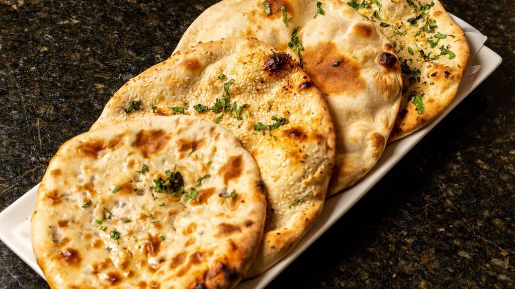 Bullet Naan · Not for the faint-hearted, white flour leavened bread baked with a blend of serrano, habanero peppers, and baked in the tandoor.
