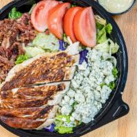 Cobb Salad · Grilled chicken with chopped romaine hearts, crumbled blue cheese, hard-boiled egg, bacon, t...