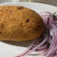 Papa Rellena · Potato croquettes stuffed with beef served with salsa criolla.