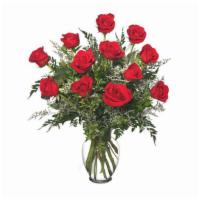 One Dozen Red Roses Arrangement In Clear Vase    · One dozen premium roses arranged in a clear vase with greens and Mist or Baby's Breath accen...