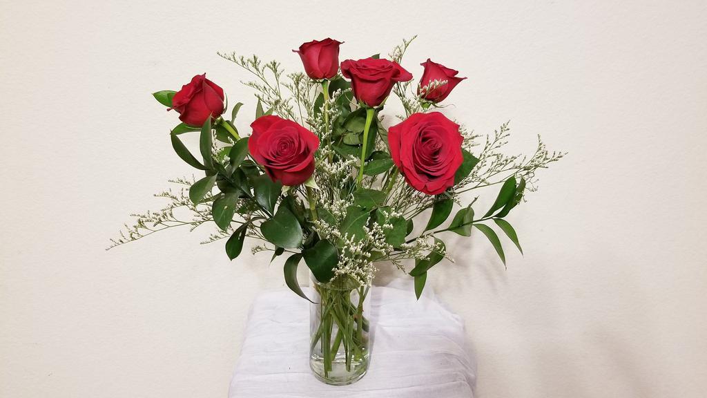 Half A Dozen Red Roses Arrangement · Half a dozen red roses with filler and greenery arrangement in clear vase.

NOTE:   All selections shown are representative of the arrangements that we can prepare for you, however due to flower availability and seasonal variations we may not be able to fill your order exactly as illustrated. Your order will be filled to the specified amount with products of an equal or greater value.  As Flower are sensitive items, the size, shade, bloom, and color might difference from the image shown.