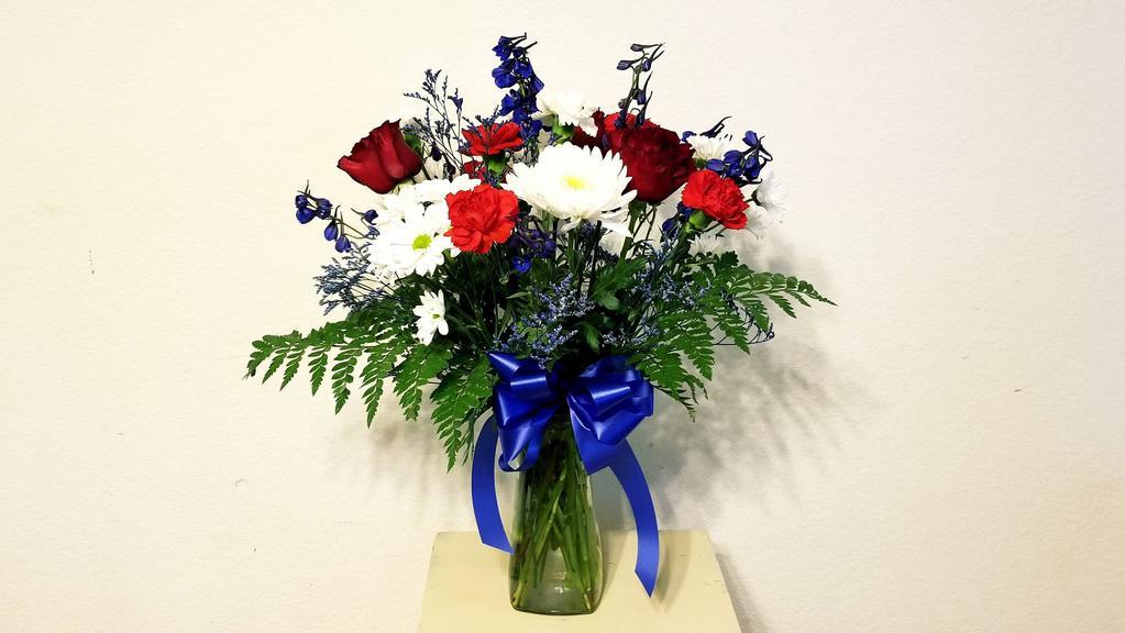 Red, White & Blue  Arrangements · All-around arrangement with red roses, white Daisy Poms, Chrysanthemum, Carnation and blue delphinium; accented with Misty and assorted greenery ***ENTER CARD MESSAGE UNDER SPECAIL INTRUCTION, PLEASE INDICATE SENDER AND RECEIVER NAME. *** NOTE: All selections shown are representative of the arrangements that we can prepare for you, however due to flower availability and seasonal variations we may not be able to fill your order exactly as illustrated. Your order will be filled to the specified amount with products of an equal or greater value. As Flower are sensitive items, the size, shade, bloom, and color might difference from the image shown.