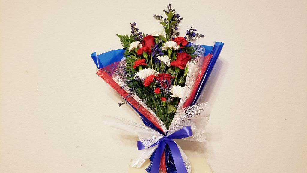 Honor A Hero Bouquet · Celebrate American pride with our patriotic bouquet. Highlighted by blue ribbon and red, white blue wraps. This hand-designed bouquet of red, white and blue blooms is a beautiful way to  honor a hero in your life. Design including red roses, white Daisy Poms, Chrysanthemum, Carnation and blue delphinium; accented with Misty and assorted greenery ***ENTER CARD MESSAGE UNDER SPECAIL INTRUCTION, PLEASE INDICATE SENDER AND RECEIVER NAME. *** NOTE: All selections shown are representative of the arrangements that we can prepare for you, however due to flower availability and seasonal variations we may not be able to fill your order exactly as illustrated. Your order will be filled to the specified amount with products of an equal or greater value. As Flower are sensitive items, the size, shade, bloom, and color might difference from the image