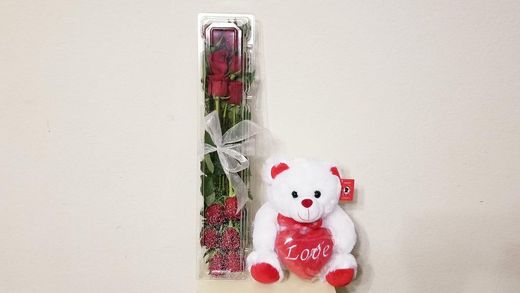 Dozen Rose Box & Love Bear · Dozen Rose Box With Silver or Gold Ribbon with Love Bear.  These rose boxes are ideal to protect your flowers during transport or outdoor during graduation ceremony. Great snap closure for security and crafted from recycled material. Pick the perfect dozen of roses and cute grad bear to enclose in this crystal clear case as you present it to your sweetheart. ***ENTER CARD MESSAGE UNDER SPECAIL INTRUCTION, PLEASE INDICATE SENDER AND RECEIVER NAME. *** NOTE: All selections shown are representative of the arrangements that we can prepare for you, however due to flower availability and seasonal variations we may not be able to fill your order exactly as illustrated. Your order will be filled to the specified amount with products of an equal or greater value. As Flower are sensitive items, the size, shade, bloom, and color might difference from the image shown.