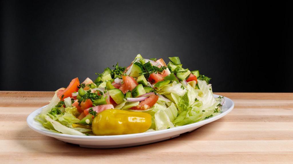 Mediterranean Salad · Chopped lettuce, tomato, cucumber, radish, onion, parsley tossed in lemon juice, olive oil, sumac and served with pita chips. Vegetarian.