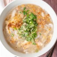 Khao Piak Sen · Thick, homemade rice noodle soup prepared with chicken, served with green onions and cilantro.