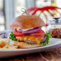 Classic Cheeseburger  · Topped with melted cheddar cheese, mayonnaise, green leaf lettuce, Roma tomatoes, and red on...