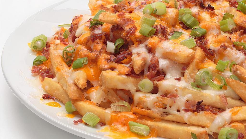 Loaded Fries  · Our seasoned fries loaded with melted Mozzarella and Cheddar, crispy bacon and fresh green onions. Served with ketchup and our Ranch.