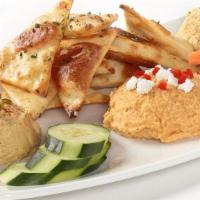 Hummus Trio · Roasted Red Pepper, South-Western, and Roasted Garlic Hummus. Served with homemade herb chip...