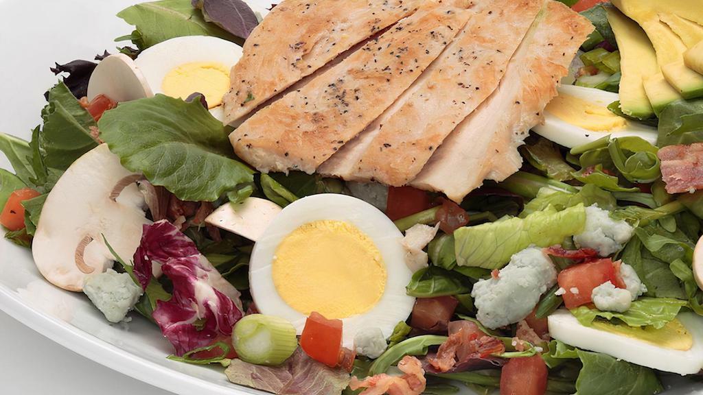 California Cobb Salad · Spring mix blend tossed with Gorgonzola cheese, tomatoes, green onions, mushrooms, hard-boiled eggs, and crispy bacon. Topped with chicken breast and avocado.  Choice of dressing.  Comes with Oggi's garlic knot.