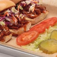 Pulled Pork Sliders · Pulled pork smothered with tangy BBQ sauce and topped with our homemade coleslaw.  Served wi...