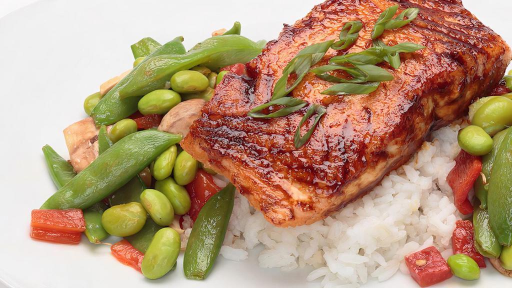 Miso Glazed Salmon · Miso Glazed 8oz salmon fillet, baked to perfection and served over sticky rice with a warm sesame soy edamame salad.  Topped with green onions.