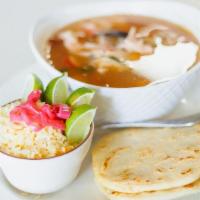 Sopa De Pescado · Seafood soup with tilapia, clams, octopus, prawns, and seafood broth with cilantro sprigs.
